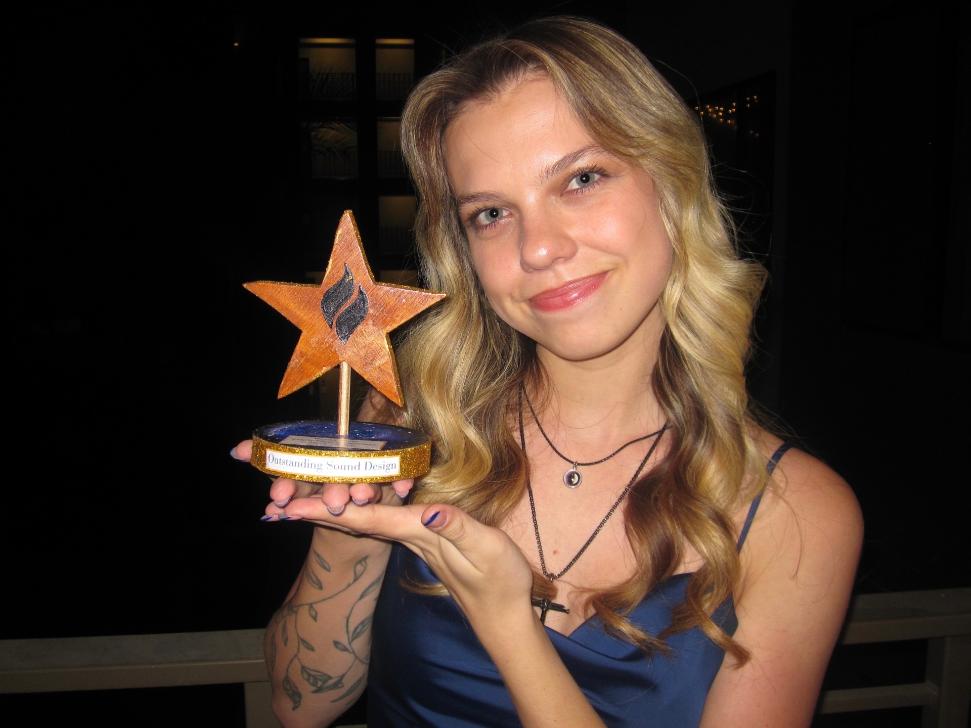 Raven Flaig, sound designer and creative director, holding an award